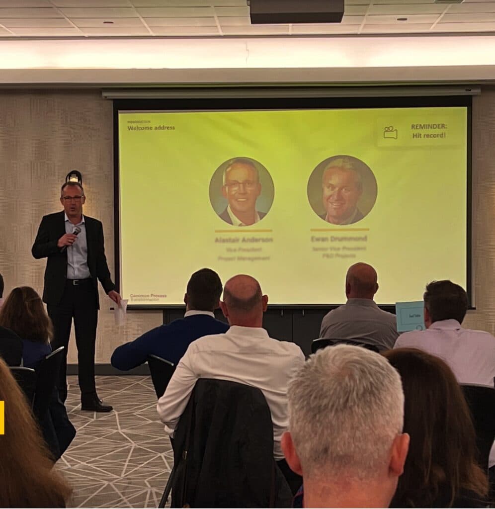 Executive presenting the HOBA Common Process Transformation framework to stakeholders. Executive presenting the HOBA Common Process Transformation framework to stakeholders.