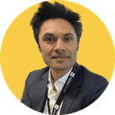 Heath Gascoigne headshot Heath Gascoigne, founder and CEO, round yellow headshot photo